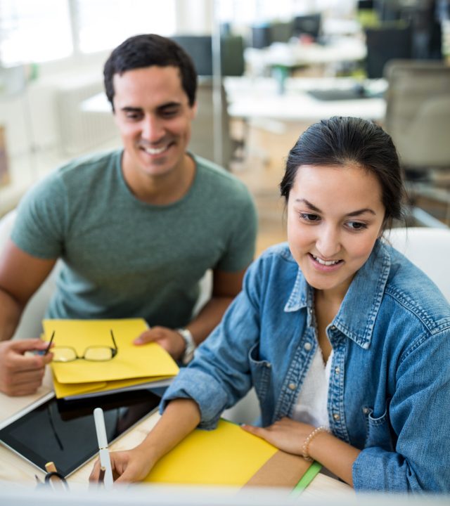 Male and female graphic designers working together in office