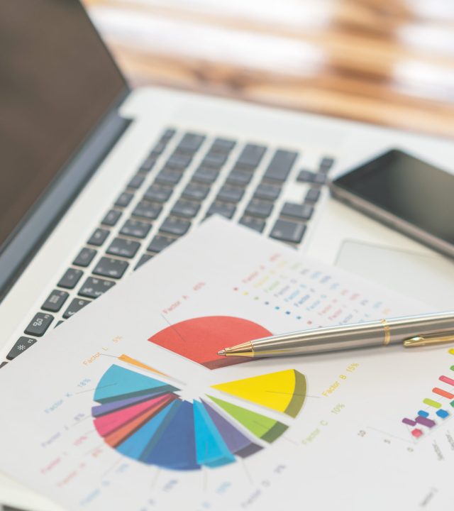 Financial charts on the table with laptop