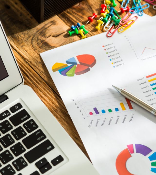 Financial charts on the table with laptop